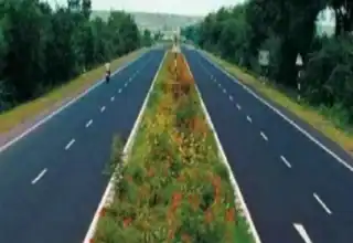 Lush greenery along a divided highway in Seemanchal, showcasing scenic beauty and infrastructure.