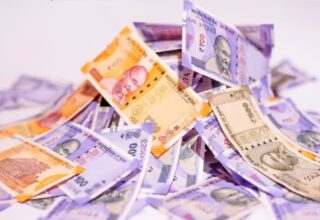 Indian currency notes, 100 and 2000 rupees, scattered on a white background.
